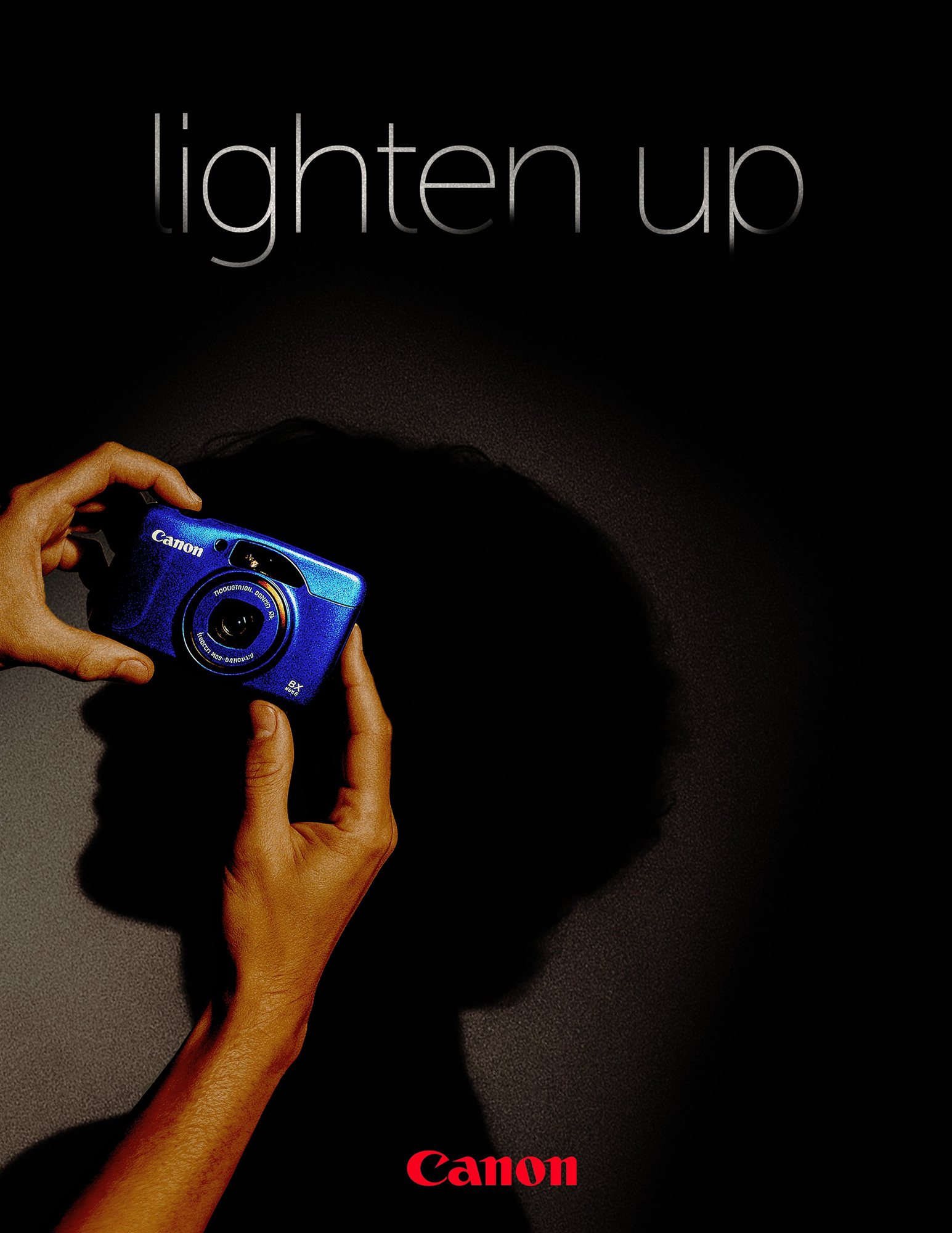 Lighten Up poster with a blue Canon PowerShot.